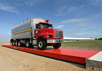 Thurman Diamondback 8560 steel deck truck scale in orange, showing the diamond-tread deck and open-bottom I-beam understructure