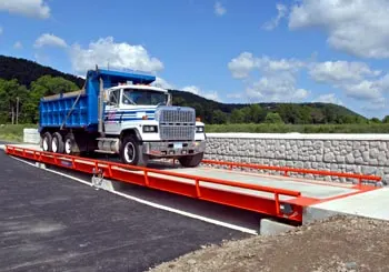 Thurman Diamondback 8550 field pour truck scale, showing the poured concrete deck, orange steel modules and 15 in. low profile