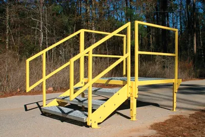 Thurman safety stair platform in yellow powder coat, 4 ft x 4 ft grip strut landing with handrails at a truck scale deck