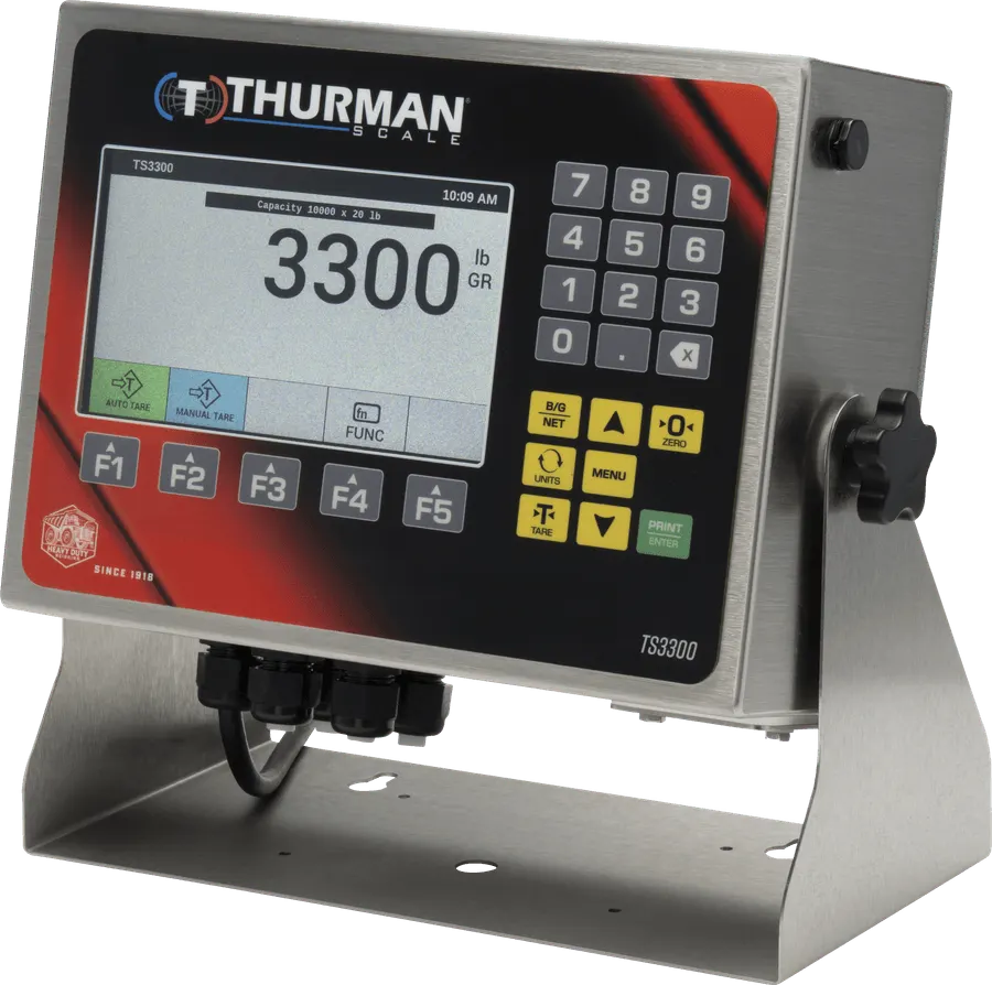 TS3302 analog scale indicator in a NEMA 4X stainless steel washdown housing on a desk and wall stand, 7-inch color display and numeric keypad.