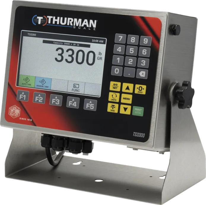 TS3302 analog scale indicator in a NEMA 4X stainless steel washdown housing on a desk and wall stand, 7-inch color display and numeric keypad.